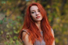 Outdoors Portrait Of Beautiful Young Woman With Red Hair