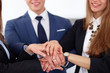© rogerphoto - Business people group joining hands and representing concept of friendship and teamwork