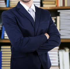 Poster - Man in suit on blurred bookshelves background