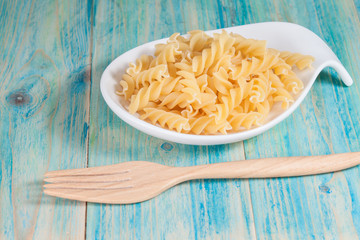 Raw spiral macaroni in plate