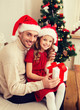 © Syda Productions - smiling father and daughter holding gift box