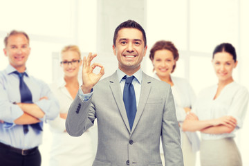 Canvas Print - happy businessman in suit showing ok hand sign