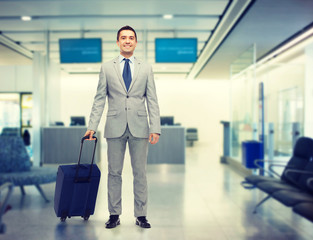 Poster - happy businessman in suit with travel bag