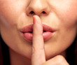 © Syda Productions - close up of young woman holding finger on lips