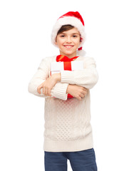 Wall Mural - smiling happy boy in santa hat with gift box