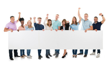 Wall Mural - Creative Business Team With Arms Raised Holding Blank Billboard