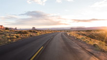Driving USA: Sunset Sunrise Point Of View Shot Along Empty Desert Highway Through Monument Valley, Arizona Utah