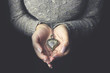 Heart necklace in woman hands.