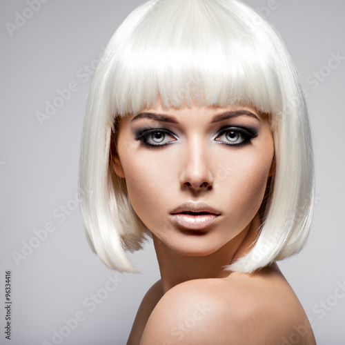 Naklejka na meble Fashion portrait of young woman with blond hairs and black make