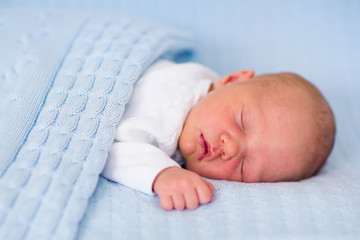 Wall Mural - newborn baby boy on a blue blanket