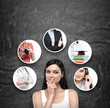 © ImageFlow - A portrait of a young artful brunette lady who is trying to chose the right career path. A range of images with different careers are drawn on the black chalkboard.