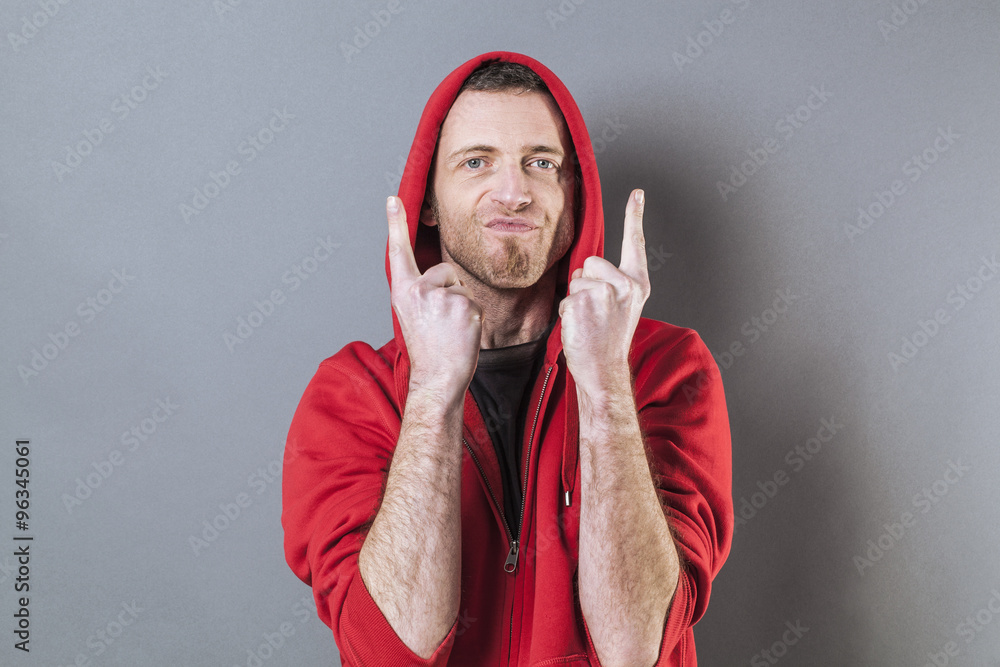 male fighting concept - playful middle age male rapper showing something with both hands and  fingers pointing up for attitude,studio shot - obrazy, fototapety, plakaty 
