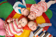 © highwaystarz - Overhead View Of Babies Lying On Mat At Playgroup