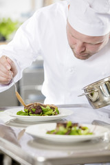 Wall Mural - Professional chef prepare meat dish at restaurant