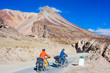 © lkoimages - Two cyclist standing on mountains road. Himalayas, Jammu and Kashmir State, North India