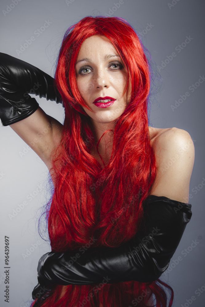 Spanish woman with long red hair, nude color and long black late Stock Photo | Adobe Stock