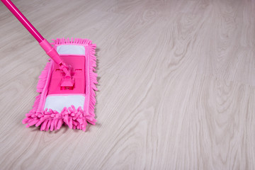 Wall Mural - cleaning concept -close up of mop on wooden floor