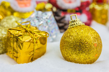 Christmas background with a golden gift box in snow