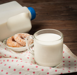 Wall Mural - Glass of milk with doughnut on wood