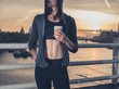 © LoloStock - Athletic young woman with cup in London at sunrise
