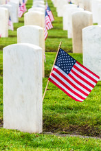 Military Veterans White Granite Tombstones With American Flags At Cemetery. Arlington Of The West. Vertical.