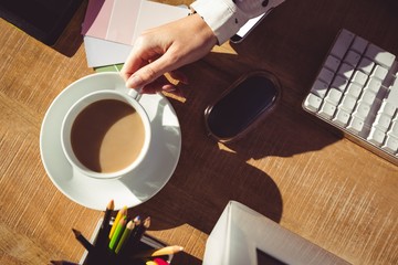 Cropped image of woman holding coffee cup