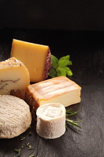 Variety Of Gourmet Cheeses With Fresh Herbs
