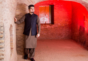 Portrait of young Man in a traditional Pathan dress with modern