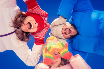 Poster - Children hands in red gloves against winter sky