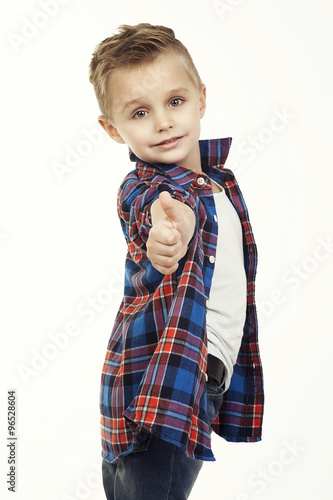 Naklejka dekoracyjna Funny child.fashionable little boy in glasses, jeans, white t-shirt and plaid shirt.stylish kid in sport shoes. fashion children