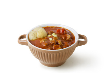 Beef stew in bowl with tomato sauce , isolated  background