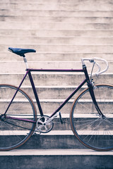 Road bicycle and concrete stairs, urban scene vintage style
