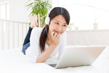 Wall Mural - young asian woman using laptop