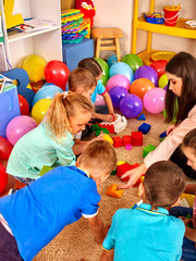 Group children game blocks on floor .