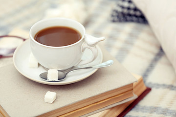 Poster - Cup of coffee with books on sofa in living room