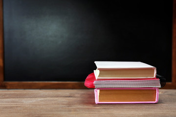 Poster - School equipment on desk on blackboard background