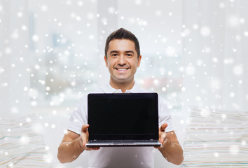 Poster - happy man showing laptop blank screen at home