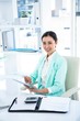 © WavebreakMediaMicro - Smiling businesswoman with notes at desk