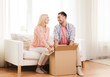 © Syda Productions - happy couple with cardboard box or parcel at home