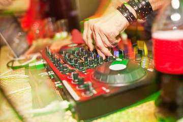 Wall Mural - DJ mixing music on console at the night club