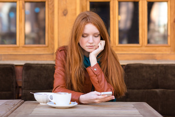 Sticker - Pretty thoughtful girl with red hair drinking coffee outdoor