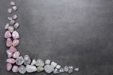 Poster - Frame of rock crystal and pink quartz on grey background, copy space