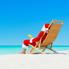 Sticker - Christmas Santa Claus with cocktail on deckchair at tropical beach