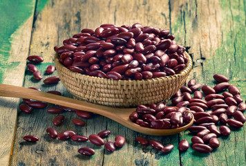 Red beans in the wooden bowl on old wooden