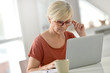 © goodluz - Senior woman at home using laptop computer