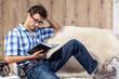man relaxing on sofa couch reading novel story book