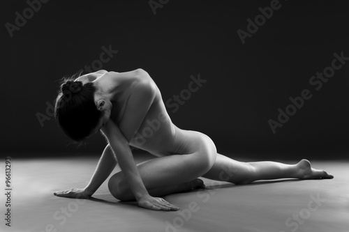 Fotografiet Naked yoga. Beautiful sexy body of young woman on gray background