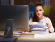 © shefkate - Young woman working in office, sitting at desk