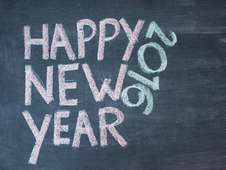 Happy new year 2016, hand writing with chalk on blackboard, vint