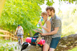 © anetlanda - couple hikers resting in forest drinking water